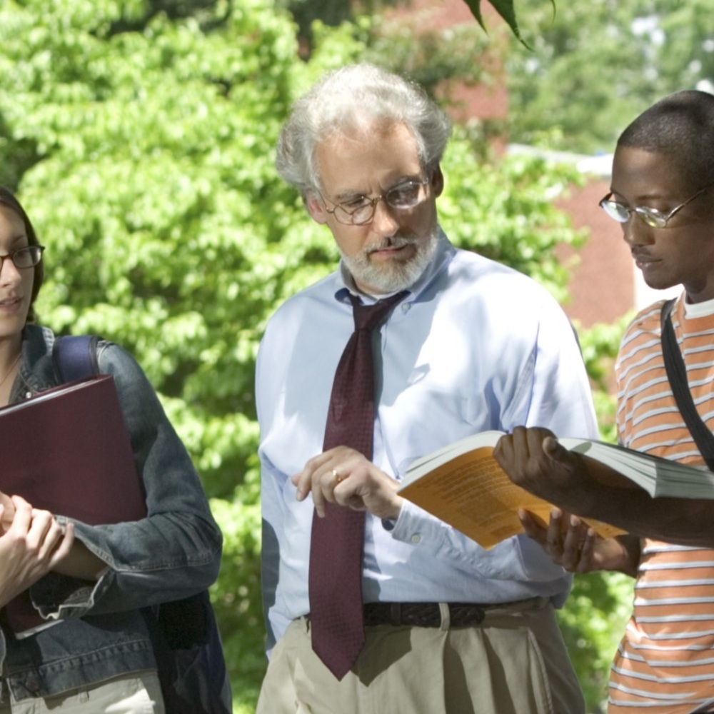 Professor walks on campus with students